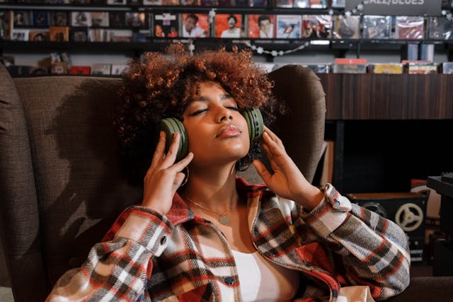 A woman listening to binaural beats in headphones