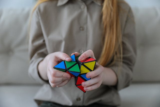 A woman completing a triangular Rubik